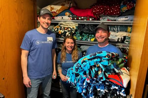 3 ORRM employees standing in front of a blanket closet
