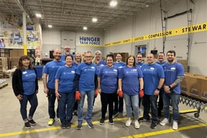 ORRM employees posing for a picture in a warehouse