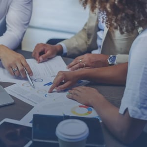 A team discussing reporting data