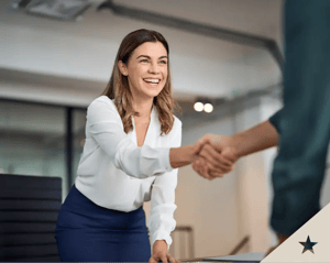 woman smiling and giving a handshake